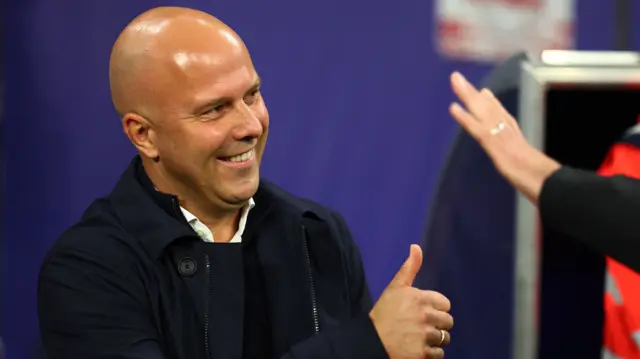 Manager Arne Slot gives a thumbs-up before Liverpool's Champions League game away to RB Leipzig