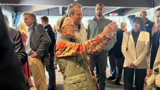 Kemp and an elderly voter take a selfie