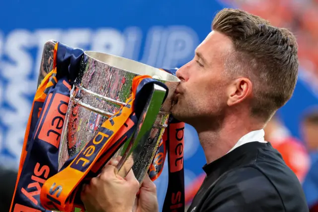 Rob Edwards kisses the 2023 Championship play-off winners' trophy