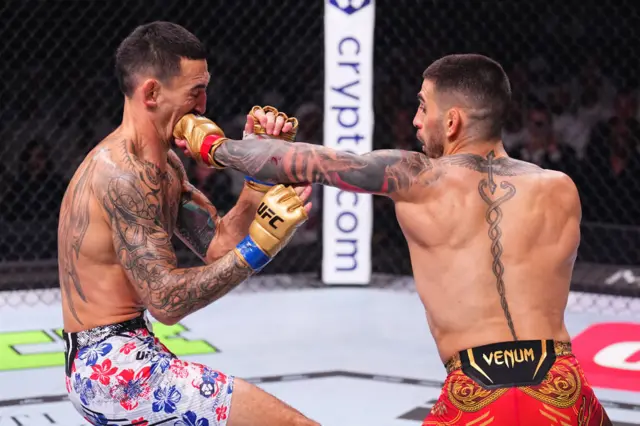 Ilia Topuria of Spain punches Max Holloway