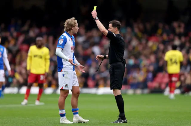 Blackburn Rovers' Todd Cantwell (left) receives a yellow card from referee Darren England