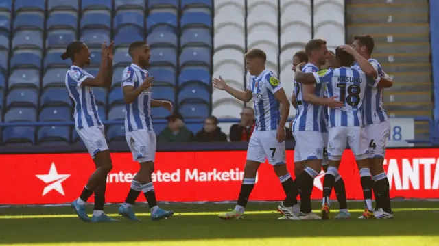 Huddersfield players celebrate Matty Pearson's goal against Exeter.