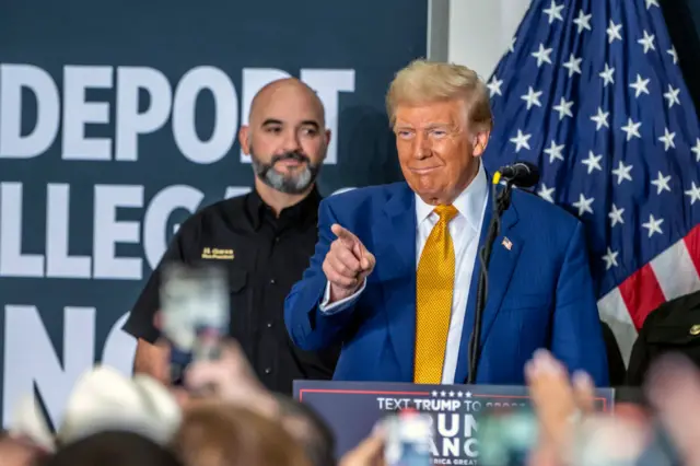 Trump points to the crowd with one finger