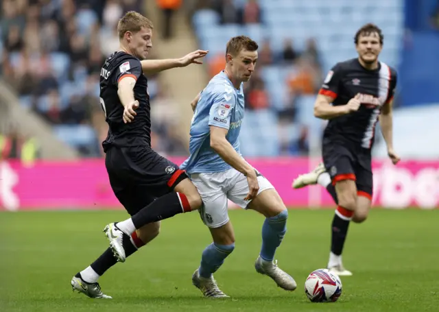 Coventry City's Ben Sheaf (centre right) is fouled by Luton Town's Mark McGuinness (left)