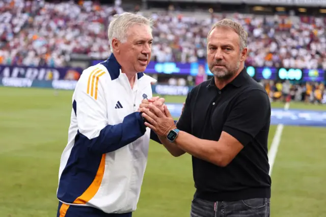 Real Madrid's Italian coach Carlo Ancelotti (L) and FC Barcelona head coach Hansi Flick