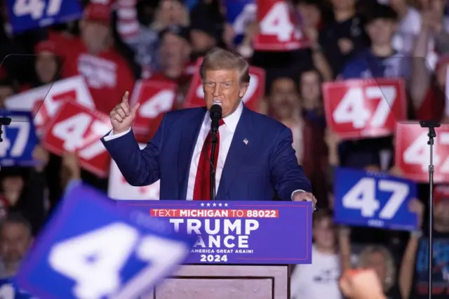 Trump with his hand raised