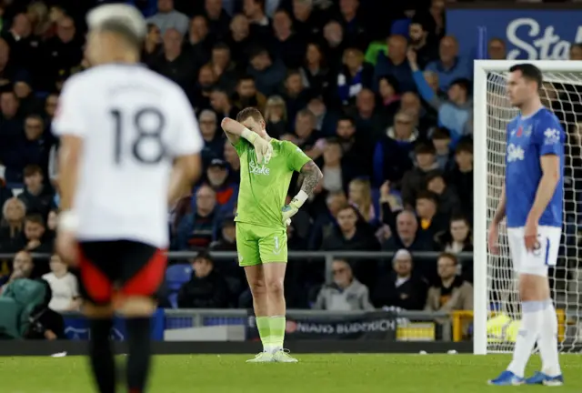 Pickford wipes his face