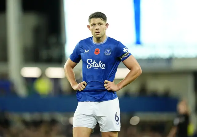 Tarkowski stands with his hands on his hips