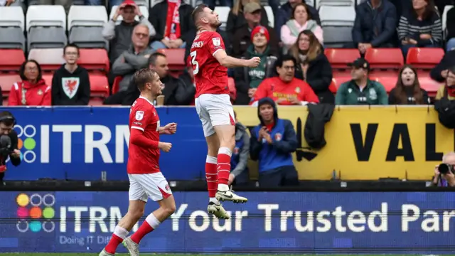 Charlton's Macauley Gillesphey jumps in celebration after scoring against Wrexham.