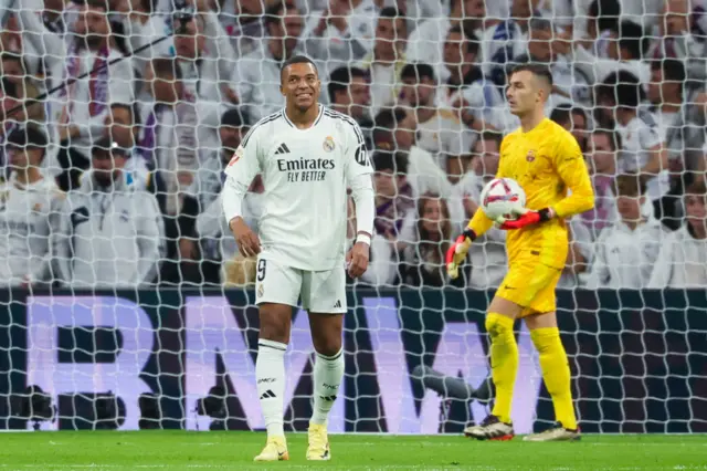 Mbappe looks ruefully at the scoreboard as it confirms his goal is ruled out