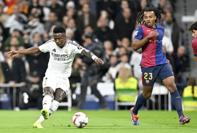 Vinicius Junior (L) of Real Madrid in action against Jules Kounde