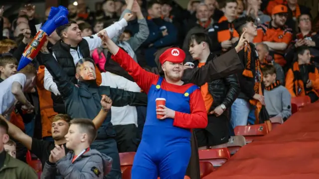 ABERDEEN, SCOTLAND - OCTOBER 26: A Dundee United fan dresses up as Mario during a William Hill Premiership match between Aberdeen and Dundee United at Pittodrie Stadium, on October 26, 2024, in Aberdeen, Scotland. (Photo by Craig Williamson / SNS Group)