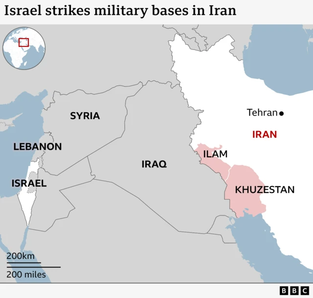 Map titled Israel strikes military bases in Iran. Shows Israel and Iran highlighted in white, with Iran's capital Tehran marked out and two provinces highlighted in red - Ilam and Khuzestan. Lebanon, Syria and Iraq are also marked