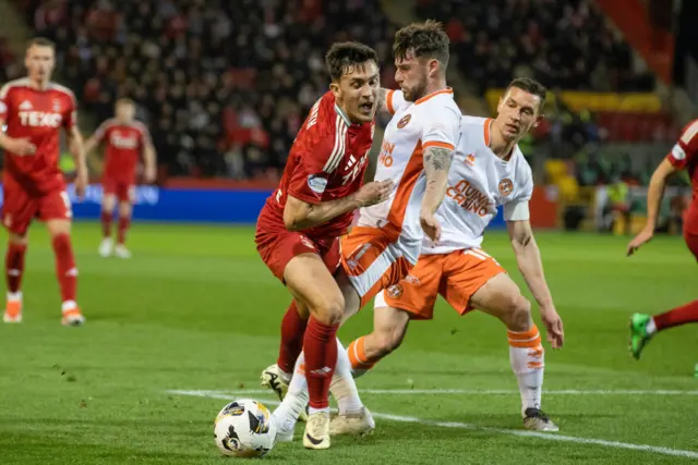 ABERDEEN, SCOTLAND - OCTOBER 26: Aberdeen's Jamie McGrath and Dundee United's Ryan Strain in action during a William Hill Premiership match between Aberdeen and Dundee United at Pittodrie Stadium, on October 26, 2024, in Aberdeen, Scotland. (Photo by Alan Harvey / SNS Group)