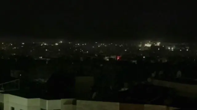 An image showing Tehran in darkness on Saturday morning local time