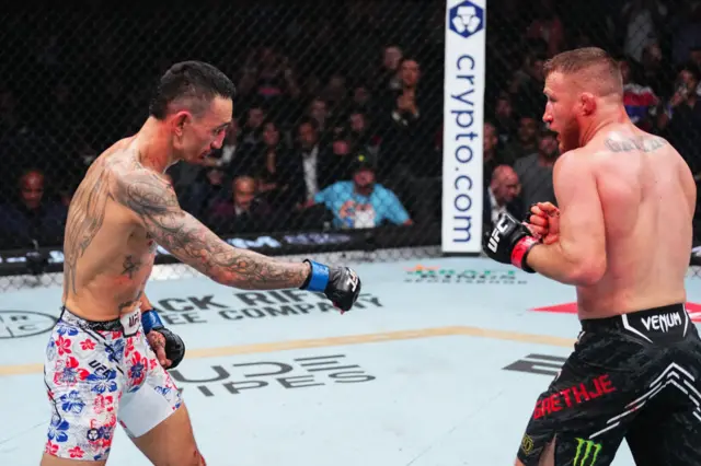 Max Holloway points to the ground in his fight with Justin Gaethje