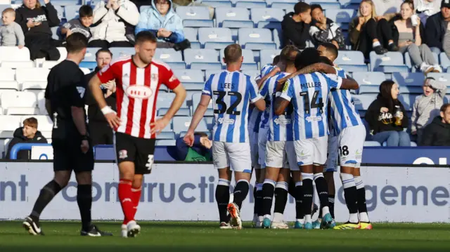 Huddersfield players celebrate Ben Wiles' goal.