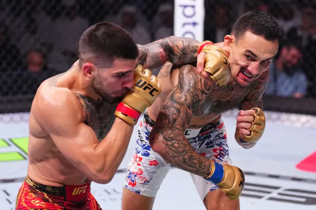 Ilia Topuria of Spain punches Max Holloway