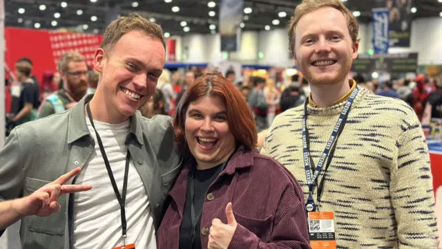 Andrew Rogers, Laura Cress, and Thomas Copeland, all smiling in front of the camera