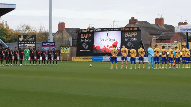 Birmingham and Mansfield players stand in silence at Field Mill for Remembrance Sunday.