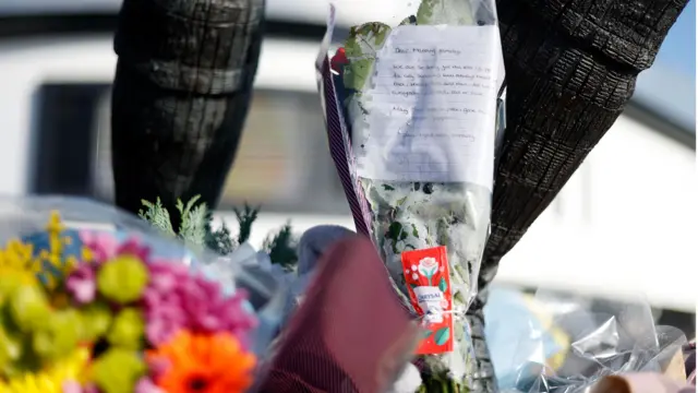 Floral tributes to Theo Manning, the son of Bristol City manager Liam Manning, outside the ground