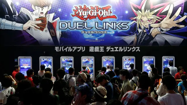 Visitors play Yu-Gi-Oh! Duel Links video game in the Konami Holdings Corp. booth at Tokyo Game Show