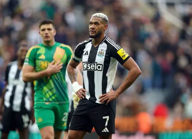 Newcastle players Joelinton and Pope stand dejected after their loss to Brighton