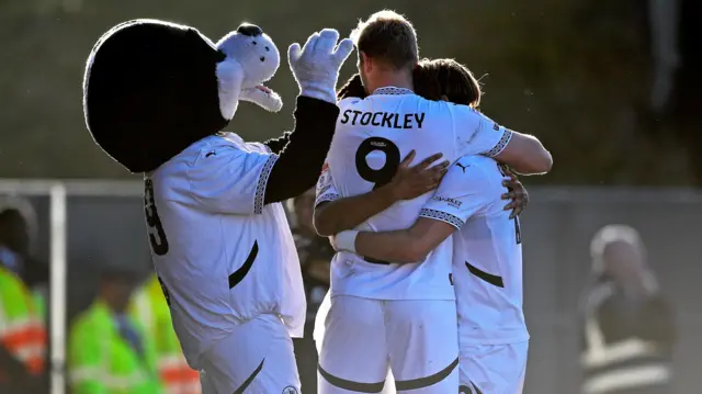 Port Vale's mascot celebrates with goalscorer Jayden Stockley.