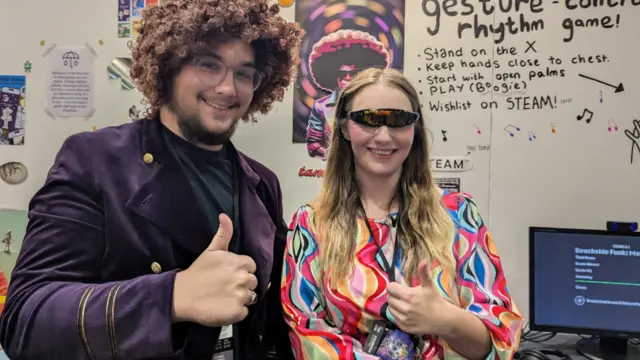 Amber and Toby looking at the camera with their thumbs up