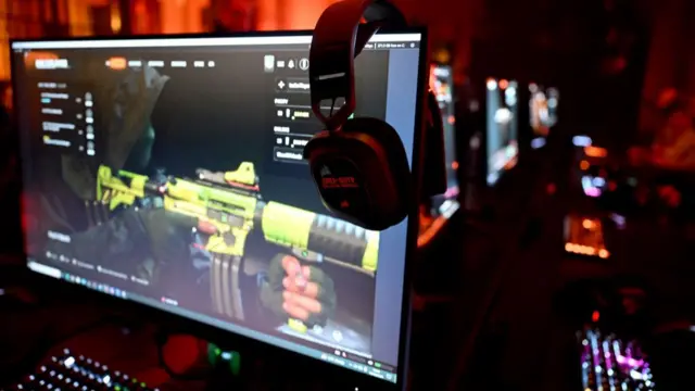 Headphones are hung from a computer screen during an event ahead of the release of Call of Duty: Black Ops 6