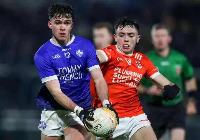 Clann Eireann's Emmett Magee challenges Clan na Gael's Callum O'Neill at the Athletic Grounds