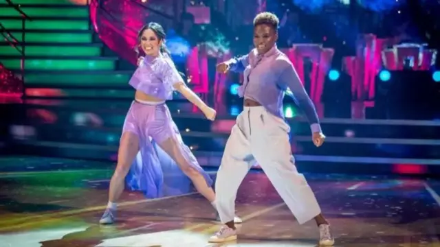 Couple dancing together wearing purple and white