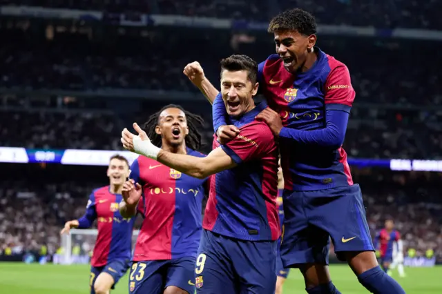 Robert Lewandowski of FC Barcelona celebrates after scoring their side's first goal with his teammate Lamine Yamal