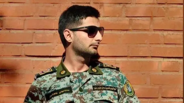 Chief Warrant Officer Mohammad Mehdi Shahrokhifar from the Iranian Army, looking off camera to the right, wearing fatigues and sunglasses