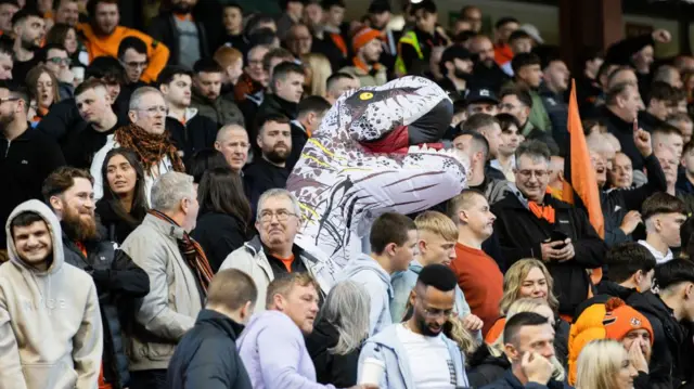 ABERDEEN, SCOTLAND - OCTOBER 26: A Dundee united fan dresses up as a dinosaur during a William Hill Premiership match between Aberdeen and Dundee United at Pittodrie Stadium, on October 26, 2024, in Aberdeen, Scotland. (Photo by Craig Williamson / SNS Group)