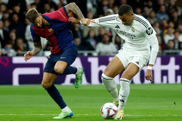 Mbappe and Martinez battle for the ball