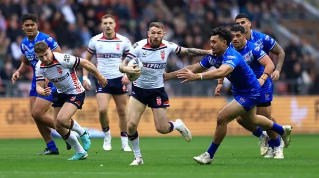 Daryl Clark of England breaks away whilst under pressure from Jeremiah Nanai