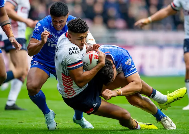 England's Kai Pearce-Paul is tackled by Samoa