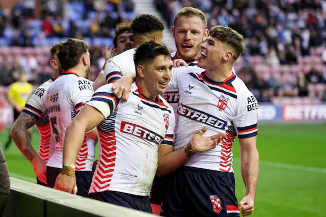 Victor Radley of England scores a try and celebrates