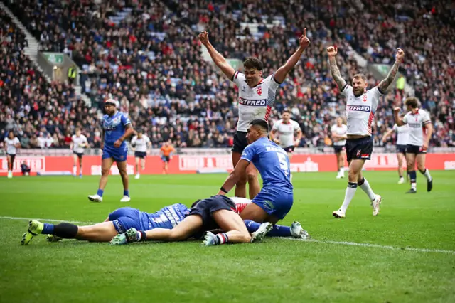 Matty Ashton of England (obscured) scores his sides second try