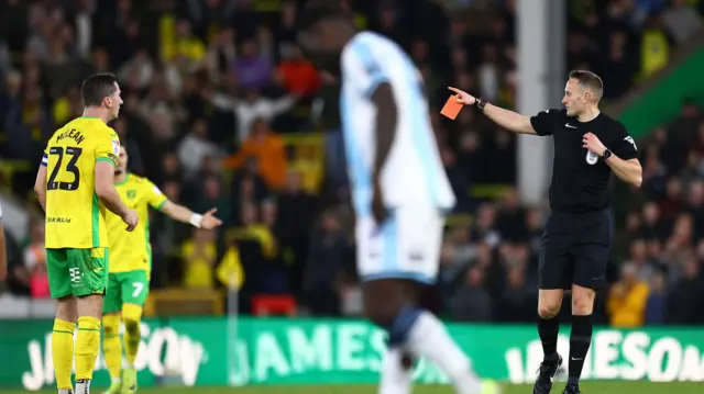 Kenny McLean of Norwich City is shown a red card