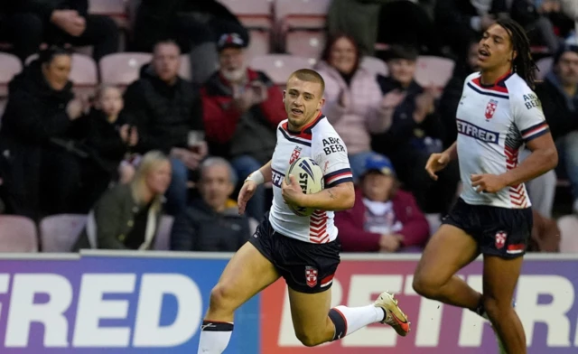 Mikey Lewis breaks away to score a try