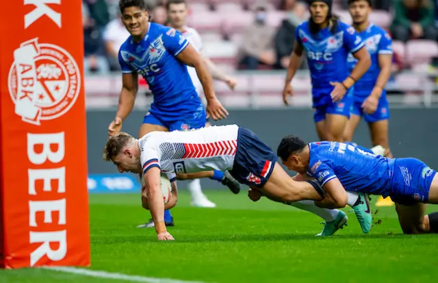 George Williams is tackled by Samoa's Roger Tuivasa-Sheck