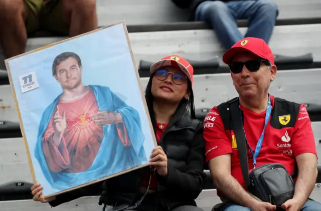 Spectators hold up a picture of Red Bull's Sergio Perez in the stands ahead of the race