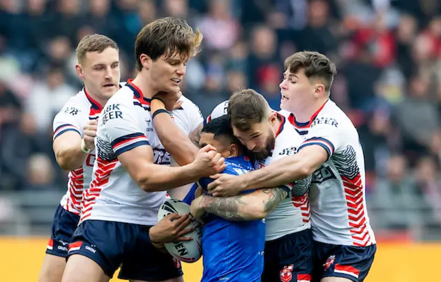 Samoa's Dean Mariner is tackled by England's Ethan Havard, Daryl Clark & Jack Welsby.