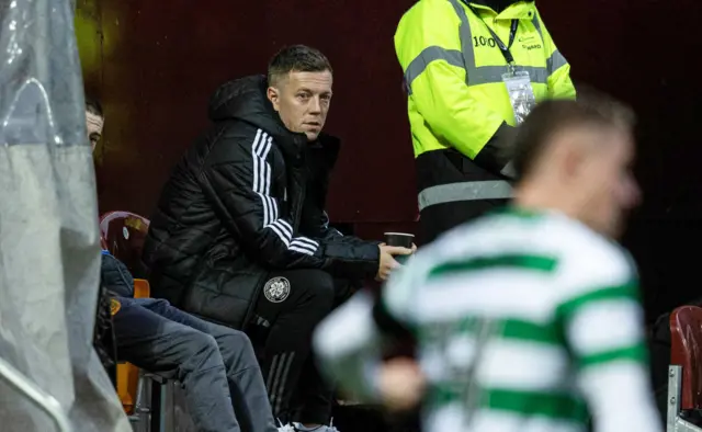 Callum McGregor watches on from pitchside