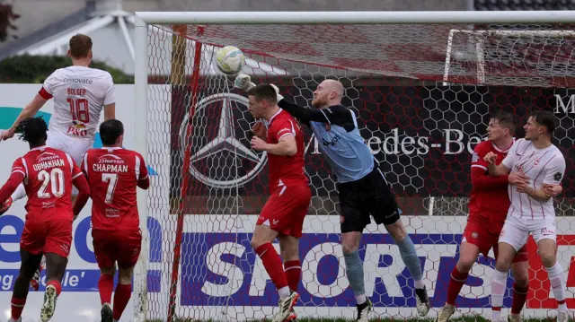 Portadown keeper Aaron McCarey keeps out this header