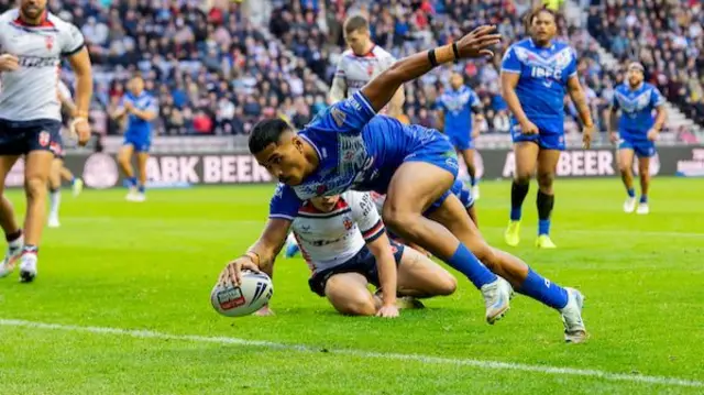 Samoa's Dean Mariner scores a try against England