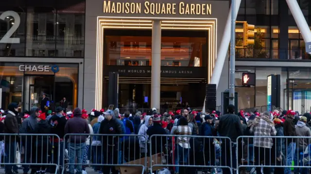 A sea of people wearing red MAGA hats is seen outside Madison Square Garden