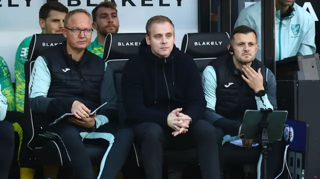 Norwich coaching staff in the dugout